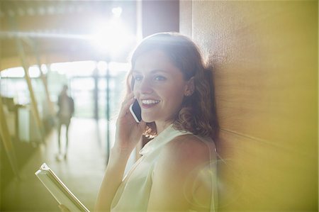 flare copyspace office - Businesswoman talking on cell phone in office Stock Photo - Premium Royalty-Free, Code: 6113-07906224