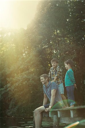 son - Father and sons relaxing at lake Stock Photo - Premium Royalty-Free, Code: 6113-07906356