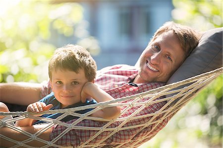 simsearch:6113-07906368,k - Father and son relaxing in hammock Stock Photo - Premium Royalty-Free, Code: 6113-07906381