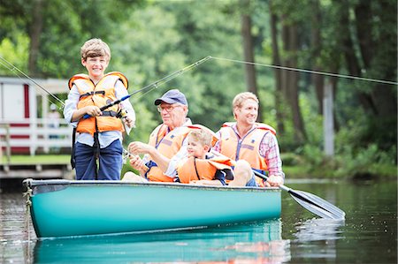 Brothers, father and grandfather fishing in lake Stock Photo - Premium Royalty-Free, Code: 6113-07906395