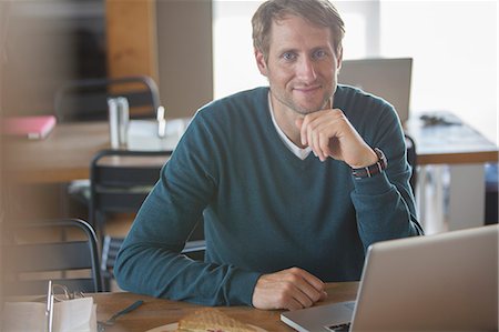 Businessman using laptop in cafeteria Stock Photo - Premium Royalty-Free, Code: 6113-07906322