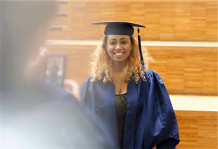 simsearch:6113-07906519,k - Female student in graduation gown posing for picture in university corridor Foto de stock - Sin royalties Premium, Código: 6113-07906450