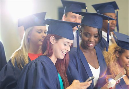 simsearch:6113-07906468,k - Students texting during graduation ceremony Stock Photo - Premium Royalty-Free, Code: 6113-07906457