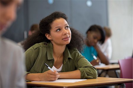 pondering in a university classroom - University student looking up during exam Stock Photo - Premium Royalty-Free, Code: 6113-07906465