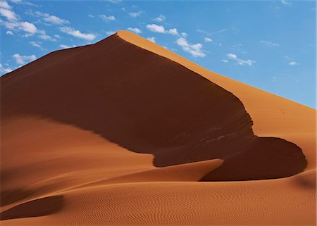 sossusvlei - View of sand dunes in desert with blue sky and clouds in background Stock Photo - Premium Royalty-Free, Code: 6113-07906400