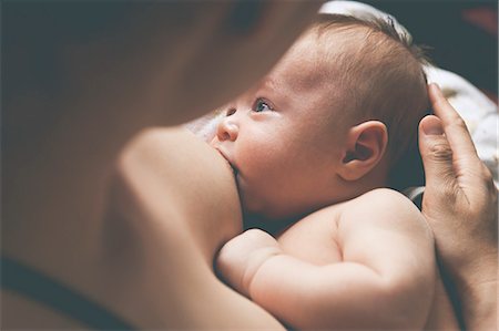 Mother holding and breast-feeding little baby Fotografie stock - Premium Royalty-Free, Codice: 6113-07906411