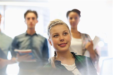 simsearch:6113-07906434,k - Four smiling university students inside classroom Stock Photo - Premium Royalty-Free, Code: 6113-07906433