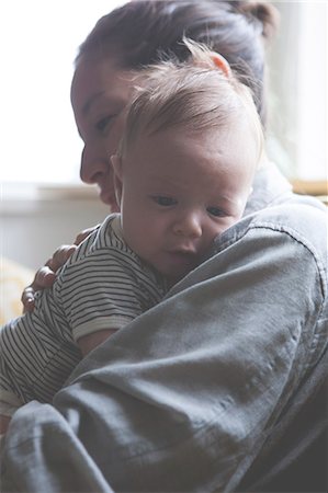 simsearch:6113-07906414,k - Portrait of mother holding little baby in striped t-shirt Photographie de stock - Premium Libres de Droits, Code: 6113-07906430