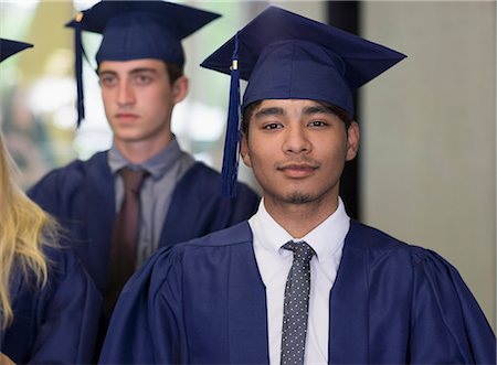 simsearch:693-06014222,k - Male student in graduation clothes looking at camera Stock Photo - Premium Royalty-Free, Code: 6113-07906540