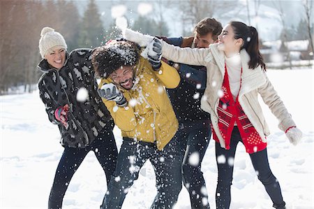Friends enjoying snowball fight Stock Photo - Premium Royalty-Free, Code: 6113-07906594