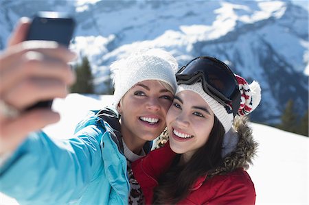 simsearch:6113-08947395,k - Friends taking selfie in snow Stock Photo - Premium Royalty-Free, Code: 6113-07906601