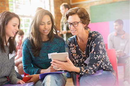 event - Woman showing digital tablet to women in community center Stock Photo - Premium Royalty-Free, Code: 6113-08087982