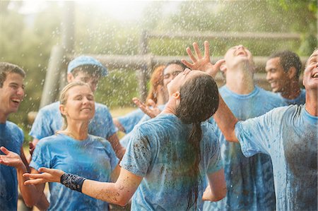 Enthusiastic team enjoying rain at boot camp Stock Photo - Premium Royalty-Free, Code: 6113-08087918