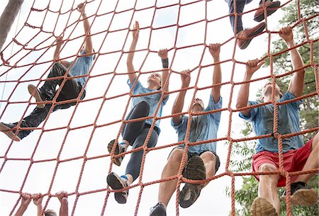 Team climbing net on boot camp course Stock Photo - Premium Royalty-Free, Code: 6113-08087930