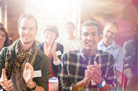 Portrait of smiling audience clapping Stock Photo - Premium Royalty-Free, Code: 6113-08088047