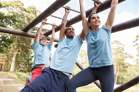 simsearch:6113-07588735,k - People crossing monkey bars on boot camp obstacle course Stock Photo - Premium Royalty-Free, Code: 6113-08088046