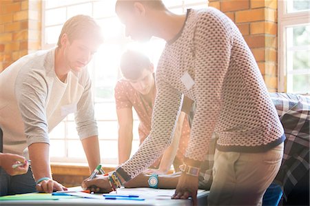 designers brainstorming in creative office meeting - Creative business people writing at table Stock Photo - Premium Royalty-Free, Code: 6113-08088068