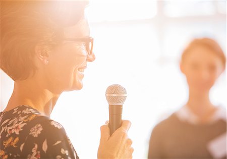 Close up woman speaking with microphone Stock Photo - Premium Royalty-Free, Code: 6113-08088070