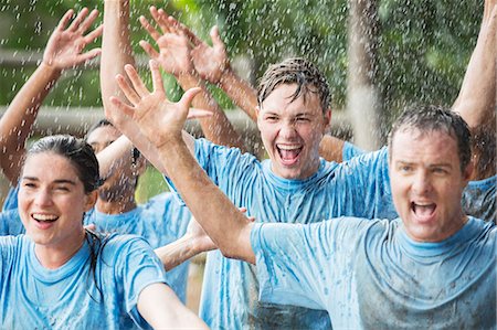 Enthusiastic team cheering in rain at boot camp Stock Photo - Premium Royalty-Free, Code: 6113-08088096