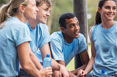Tired team resting and drinking water at boot camp Stock Photo - Premium Royalty-Free, Code: 6113-08088007
