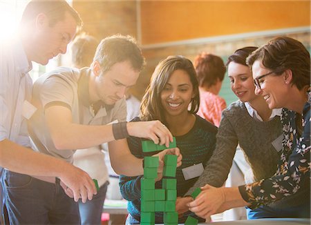 Business people stacking green blocks Stock Photo - Premium Royalty-Free, Code: 6113-08088039