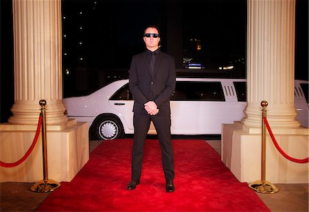 Serious bodyguard in sunglasses protecting red carpet at event Stock Photo - Premium Royalty-Free, Code: 6113-08088179