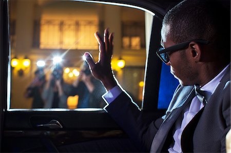 Celebrity in limousine waving at paparazzi photographers Stock Photo - Premium Royalty-Free, Code: 6113-08088180