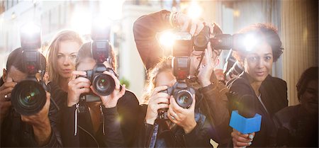 posing for the camera - Portrait of paparazzi in a row with cameras and microphone Stock Photo - Premium Royalty-Free, Code: 6113-08088138