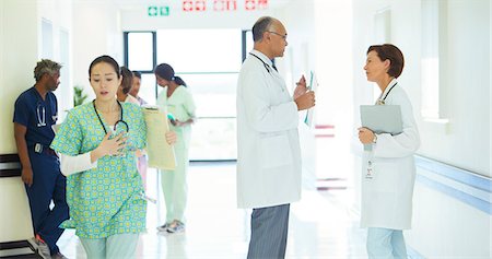 Doctors talking in hospital corridor Stock Photo - Premium Royalty-Free, Code: 6113-08088284