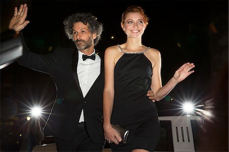 flash (camera flash) - Celebrity couple arriving and waving to paparazzi at event Stock Photo - Premium Royalty-Free, Code: 6113-08088220