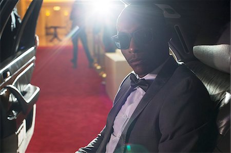 Portrait of serious celebrity in sunglasses inside limousine arriving at red carpet event Photographie de stock - Premium Libres de Droits, Code: 6113-08088225