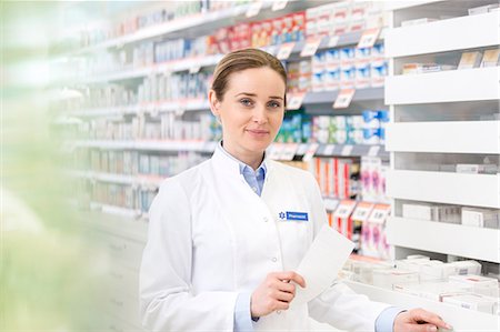 pharmacist looking at camera - Portrait of confident pharmacist holding prescription in pharmacy Stock Photo - Premium Royalty-Free, Code: 6113-08088382