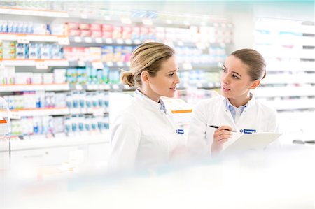 Pharmacists talking in pharmacy Stock Photo - Premium Royalty-Free, Code: 6113-08088397