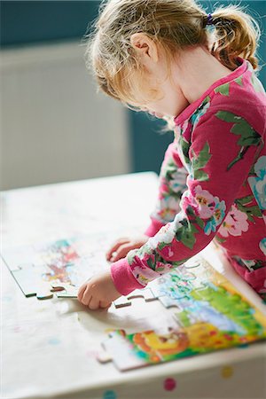 puzzles - Girl assembling jigsaw puzzle Stock Photo - Premium Royalty-Free, Code: 6113-08088324