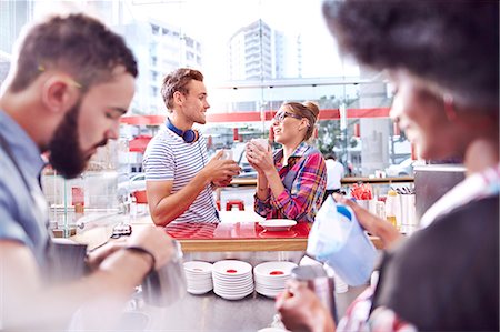 Couple talking and drinking coffee in cafe Stock Photo - Premium Royalty-Free, Code: 6113-08088488