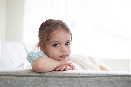 simsearch:6113-08521307,k - Portrait of serious girl on sofa Fotografie stock - Premium Royalty-Free, Codice: 6113-08088525