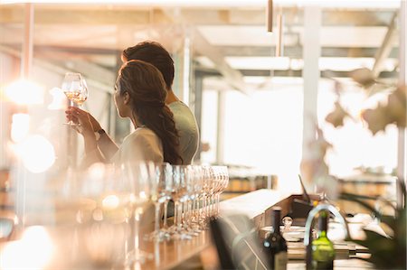 examining food - Couple wine tasting in sunny winery tasting room Photographie de stock - Premium Libres de Droits, Code: 6113-08171140