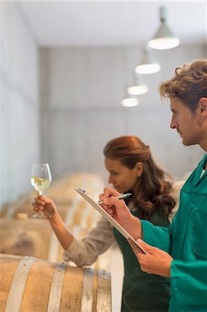 examining food - Vintners examining white wine in winery cellar Photographie de stock - Premium Libres de Droits, Code: 6113-08171168