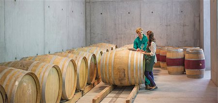 Vintners talking at barrels in winery cellar Stock Photo - Premium Royalty-Free, Code: 6113-08171187