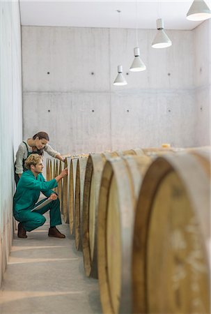 storage row - Vintners examining barrels in winery cellar Stock Photo - Premium Royalty-Free, Code: 6113-08171190