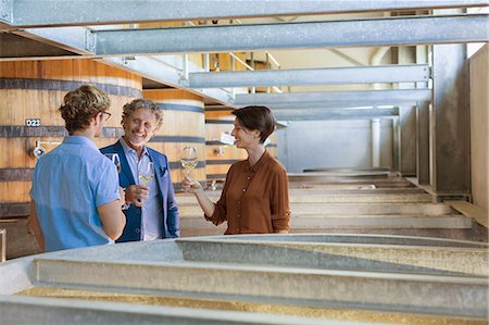 Friends barrel tasting wine in winery cellar Stock Photo - Premium Royalty-Free, Code: 6113-08171125