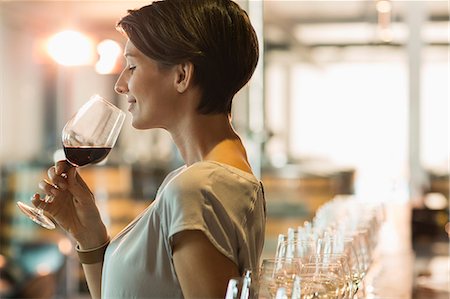 females smelling food - Woman wine tasting red wine in winery tasting room Stock Photo - Premium Royalty-Free, Code: 6113-08171218