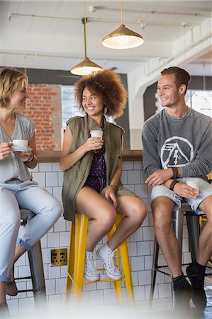 Friends hanging out talking and drinking coffee in cafe Stock Photo - Premium Royalty-Free, Code: 6113-08171334