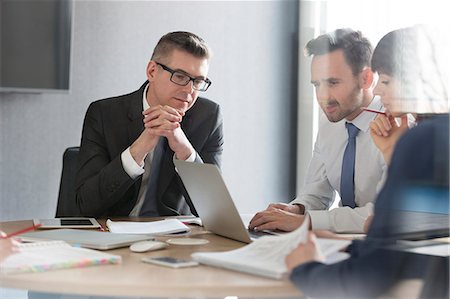 simsearch:6113-07242205,k - Business people working at laptop in conference room meeting Stock Photo - Premium Royalty-Free, Code: 6113-08171442