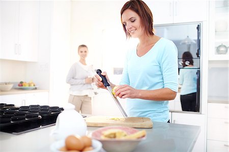 simsearch:6113-08171491,k - Woman zesting lemon in kitchen Stock Photo - Premium Royalty-Free, Code: 6113-08171491