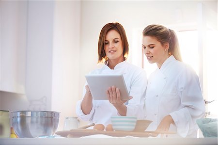 simsearch:649-05521518,k - Chefs using digital tablet in kitchen Stock Photo - Premium Royalty-Free, Code: 6113-08171497