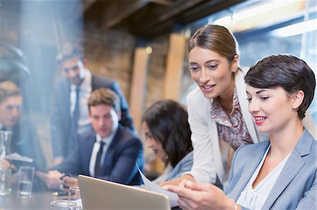 Businesswomen working with digital tablet in conference room meeting Photographie de stock - Premium Libres de Droits, Code: 6113-08184298