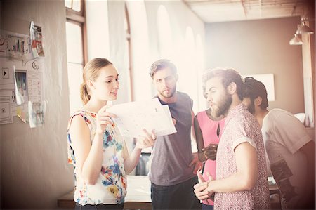 five people - Casual business people reviewing paperwork in meeting in office Stock Photo - Premium Royalty-Free, Code: 6113-08105373