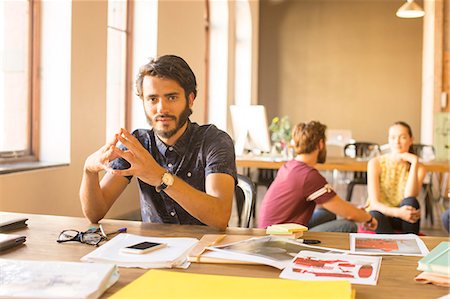 Portrait confident creative businessman working with proofs in office Stock Photo - Premium Royalty-Free, Code: 6113-08105370