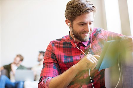 simsearch:6113-08105339,k - Casual businessman with headphones and digital tablet in office Stock Photo - Premium Royalty-Free, Code: 6113-08105375